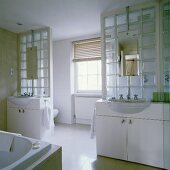 A glass-block wall and two washstands creating a doorway