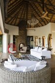 An open-plan living room in a South African house with a white sofa