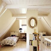 A bedroom with two single beds in a 19th century German thatched-roof house decorated in a Scandinavian style