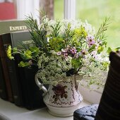 A bunch of garden flowers in a jug