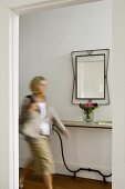 A woman in a minimalistic hallway