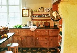 A kitchen in a farm house - a kitchen counter with old wooden drawers