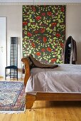 Bedroom with antique wooden bed and wall hanging with floral pattern and chair in Art Nouveau style