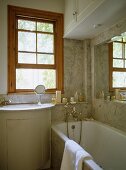 Sink set in cupboard unit next to bathtub