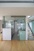 View through glass screen to modern galley kitchen
