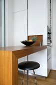 Bar stool at breakfast bar in modern kitchen