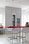 Bar stools at breakfast bar in modern kitchen