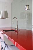 Chrome tap fitting over sink in modern kitchen