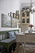 Country style dining room with green bench and wooden table