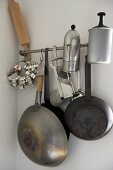 Kitchenware hanging from steel bar