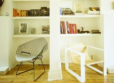 Two retro style chairs in front on white shelving unit