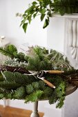 Cut pine branches and garden shears on a table