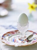 Soft boiled breakfast egg in an egg cup on a plate