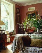 Traditional living room corner in red hues with sofa and cushions