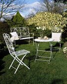 White metal garden furniture on a field