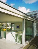 A view through an open terrace door onto a roof terrace in a living room