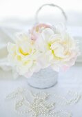 White peonies and a pearl necklace