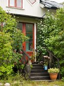 The rear entrance of a house with wooden steps