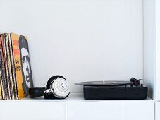 A record player with records and headphones
