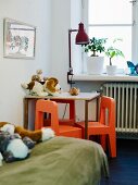 A table and small chairs in a child's room