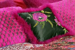 Pink decorative cushions on a bed
