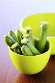 Several courgettes in green bowl
