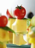 Cubes of cheese on sticks with cherry tomatoes