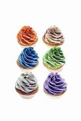 Cupcakes topped with colourful creams