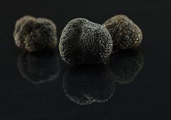 Black truffles on a black surface