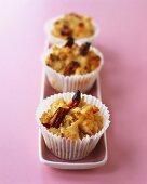 Three date and cherry muffins on an oblong plate