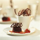 Small chocolate cake on strawberries