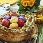 Easter wreath in choux pastry with coloured eggs