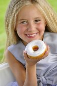 Blond girl eating doughnut