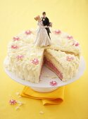 A wedding cake with a piece cut