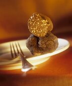 Black truffles on plate with fork