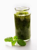 A Jar of Pesto with Basil Leaf