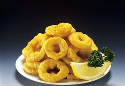 Onion Rings on a Plate with Lemon Wedge and Parsley