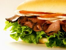 A Roast Beef Sub with Tomatoes, Onions and Lettuce