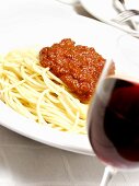 Bowl of Spaghetti with Meat Sauce; Glass of Red Wine