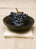 Purple Grapes in a Bowl Resting on a Towel