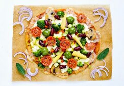 A colourful pizza with corn cobs