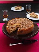 Praline cheese cake on a cake platter with a pie slice