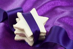 Stacked cinnamon stars wrapped with purple ribbon