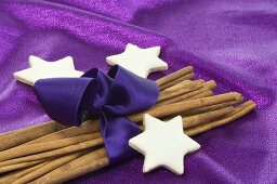 Cinnamon stars with cinnamon sticks wrapped with purple ribbon