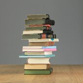 A stack of books on a wooden table