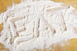 The word 'eat' written in flour