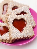 Jam biscuits with icing sugar on a plate