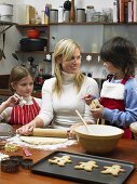 A mother and children making cookies