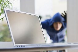 A burglar looking through a glass door