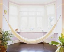 A hammock in a bay window.